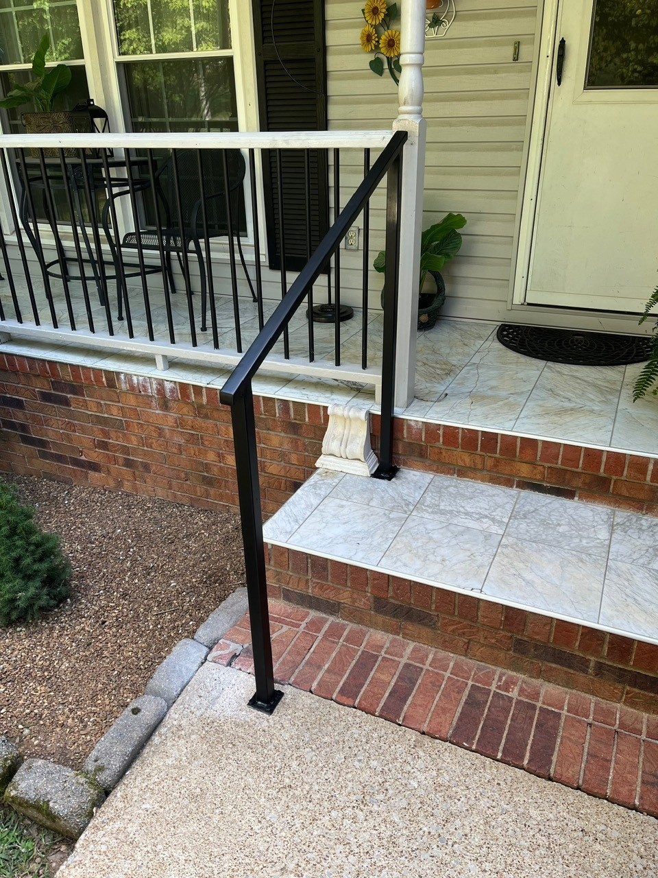 Custom handrail on brick front steps
