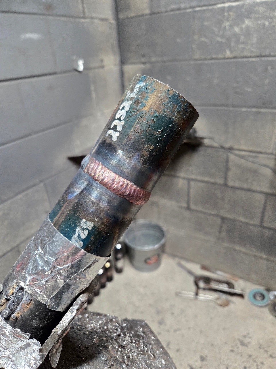 Precision pipe welding closeup showing clean bead