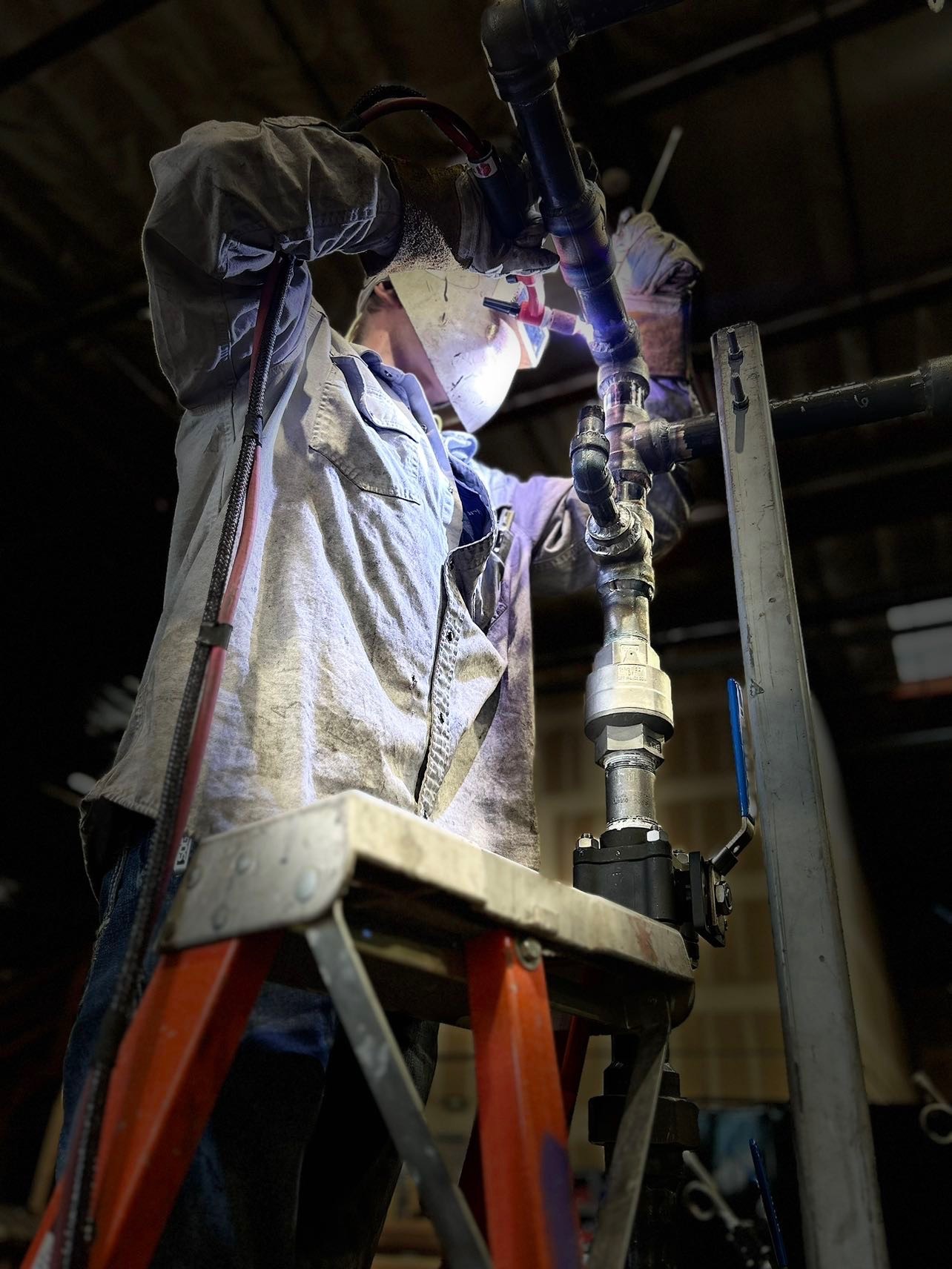 Big Town welder fabricating pipe fittings in the shop